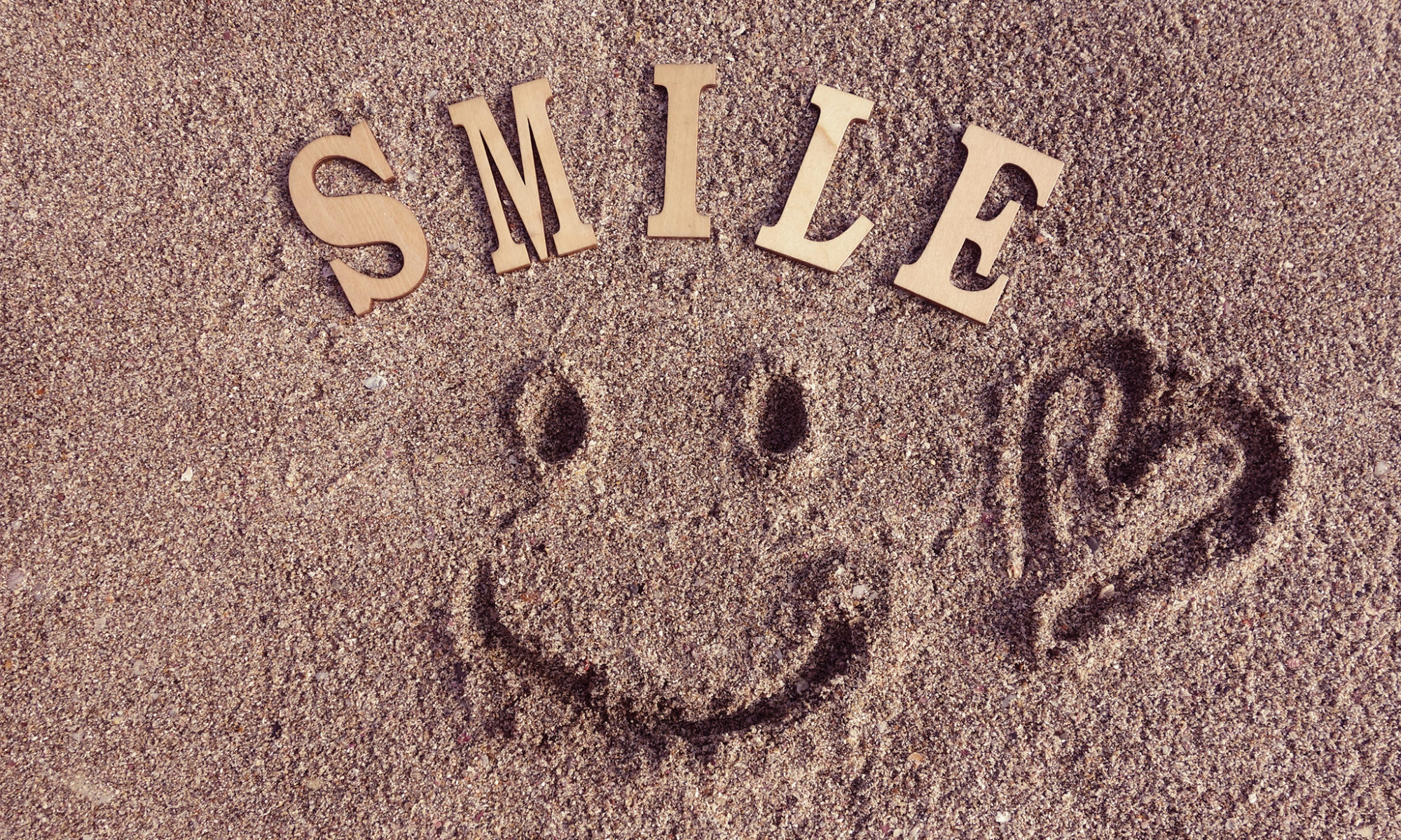 砂に描いた笑顔のイラスト